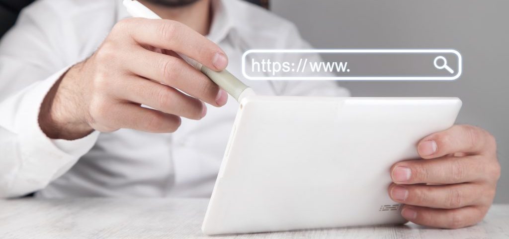 man using white digital tablet 1024x557 1